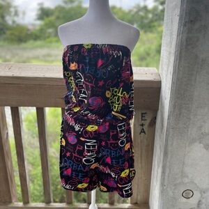 Women’s black strapless romper with multicolored graffiti print tags removed.